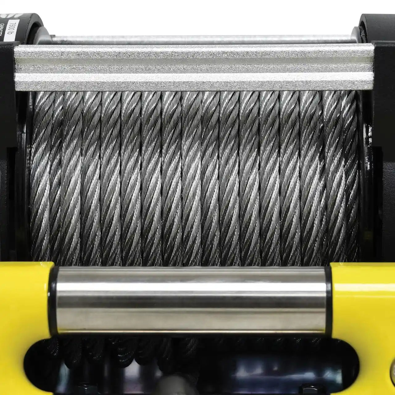 Close-up of a winch with steel coiled cable on a yellow and black winch housing.