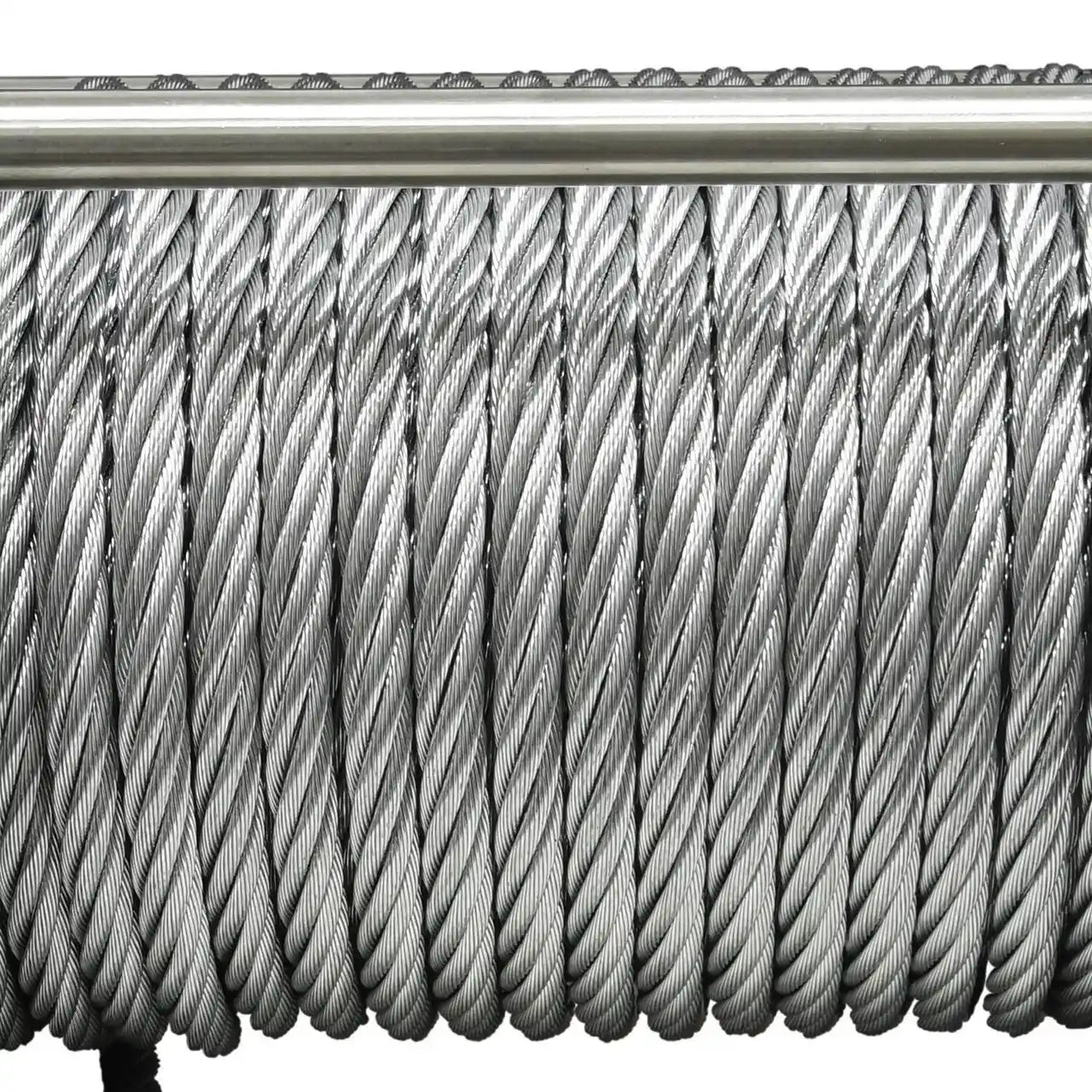 Close-up of a coiled steel cable on a white background
