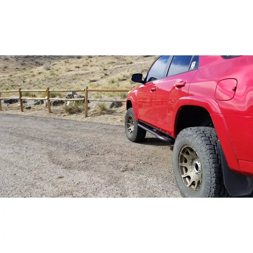 side view of the mounted rock sliders on red 4runner