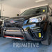 Black SUV with a front bumper  lip guard in a garage, featuring the brand 'Primitive'.