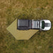Top-down view of a white truck with an open 270 awning on grassy terrain