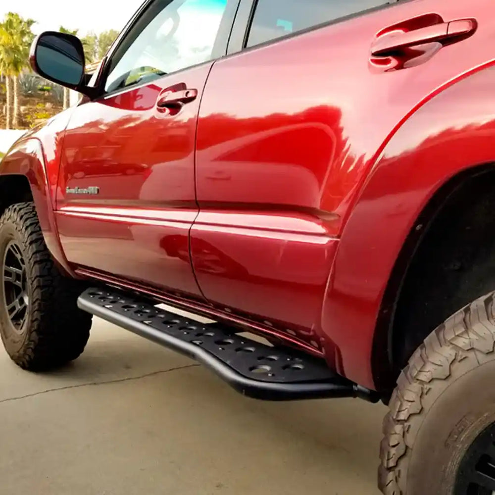 Red truck with a black running board on a concrete surface