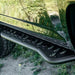 Close-up of a black vehicle side step on a grassy background