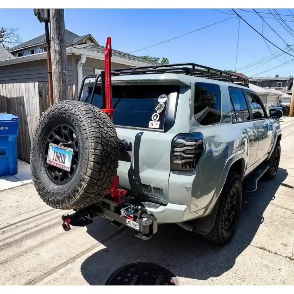 White 4Runner with Swing Out Rigid Armor tire Carrier and accessories.