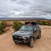 4runner with roof rack and rock sliders in a desert landscape under a cloudy sky