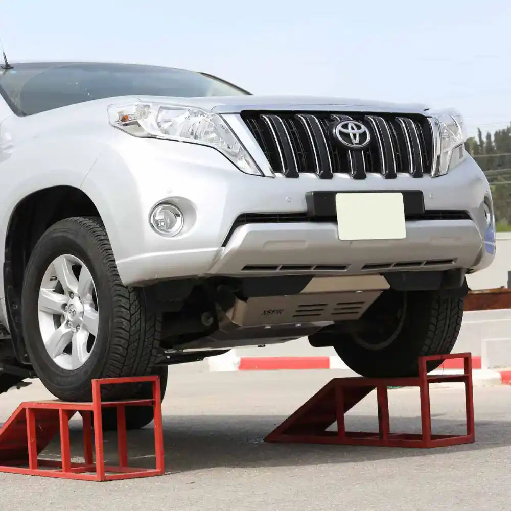 Silver Toyota SUV on a small ramp with installed front skid plate