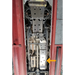 Close-up of a installed fuel tank skid plate inside a vehicle, with an arrow pointing to a specific part.
