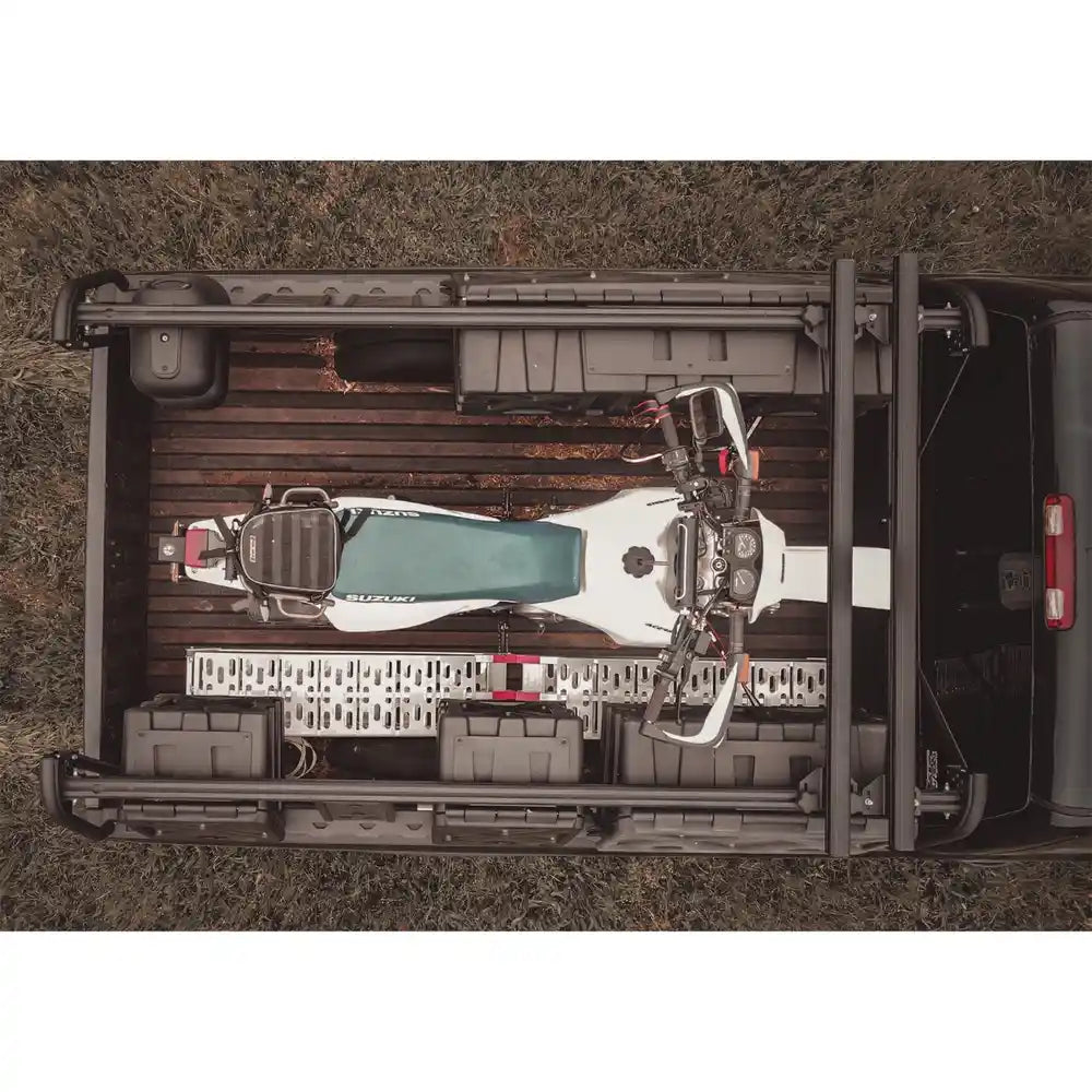 Top-down view of a motorcycle in the back of a Chevy on a grassy area