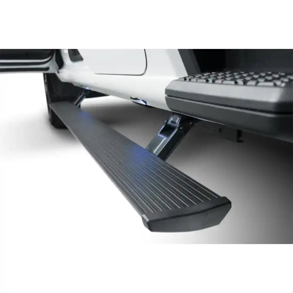 AMP PowerStep illuminated running board extended from white pickup truck