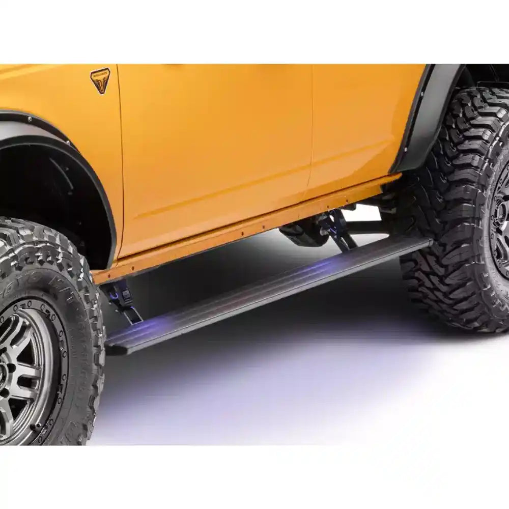 AMP PowerStep illuminated under orange Ford Bronco