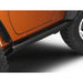 AMP PowerStep retracted under orange Jeep Wrangler
