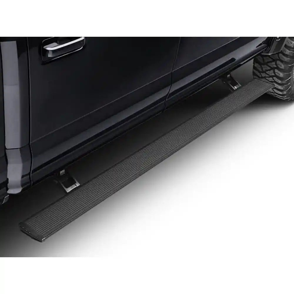 AMP Research PowerStep Xtreme retractable running boards installed on a black Ford F-150