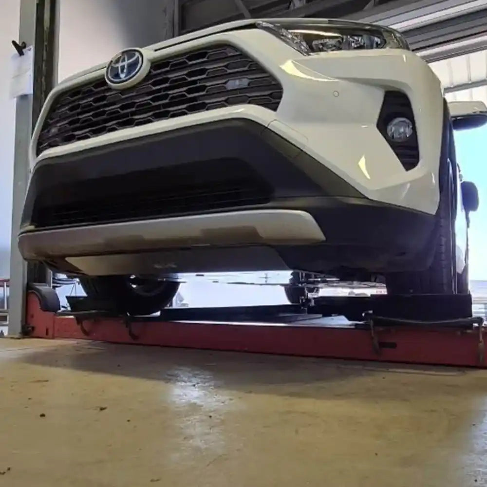 Asfir 4x4 RAV4 Highlander skid plate during installation on lift shop view