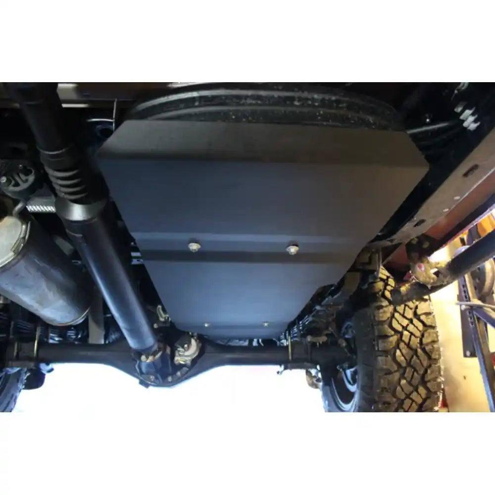 Black RCI skid plate mounted under Tacoma with visible hardware