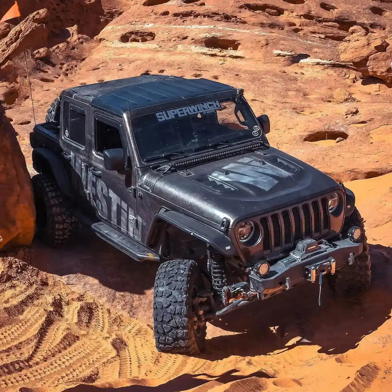 Black off-road vehicle on a rocky desert landscape