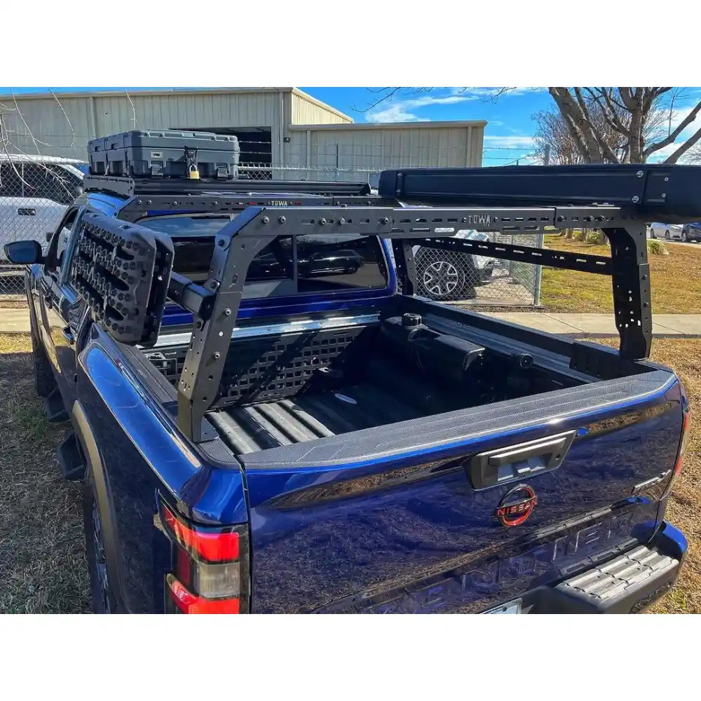 Blue Nissan with a shiprock rack and storage system in an outdoor setting