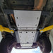 Bottom view highlighting drain access holes and bolt pattern on main skid plates