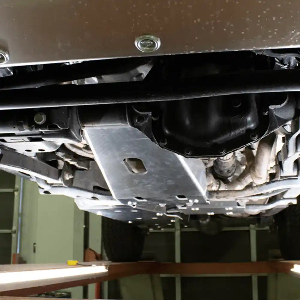 Close-up installed with exhaust viewAsfir Gladiator JT skid plate installed under engine