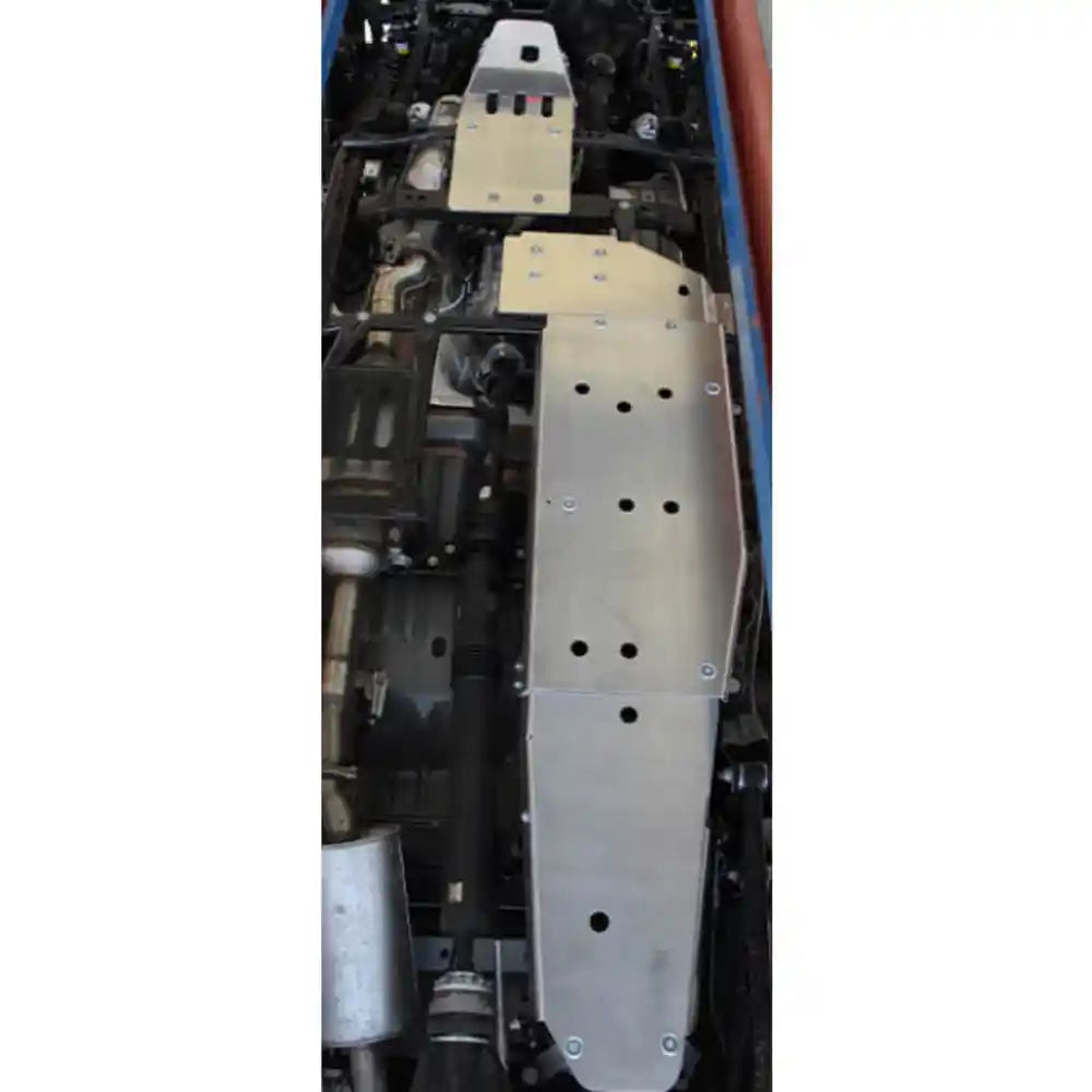 Close-up of Asfir transfer case skid plate (aluminum) installed on Jeep Gladiator JT, showing ventilation holes and drain access.