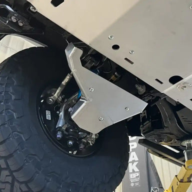 Close-up of RCI A-arm guard protecting lower control arm on Tacoma