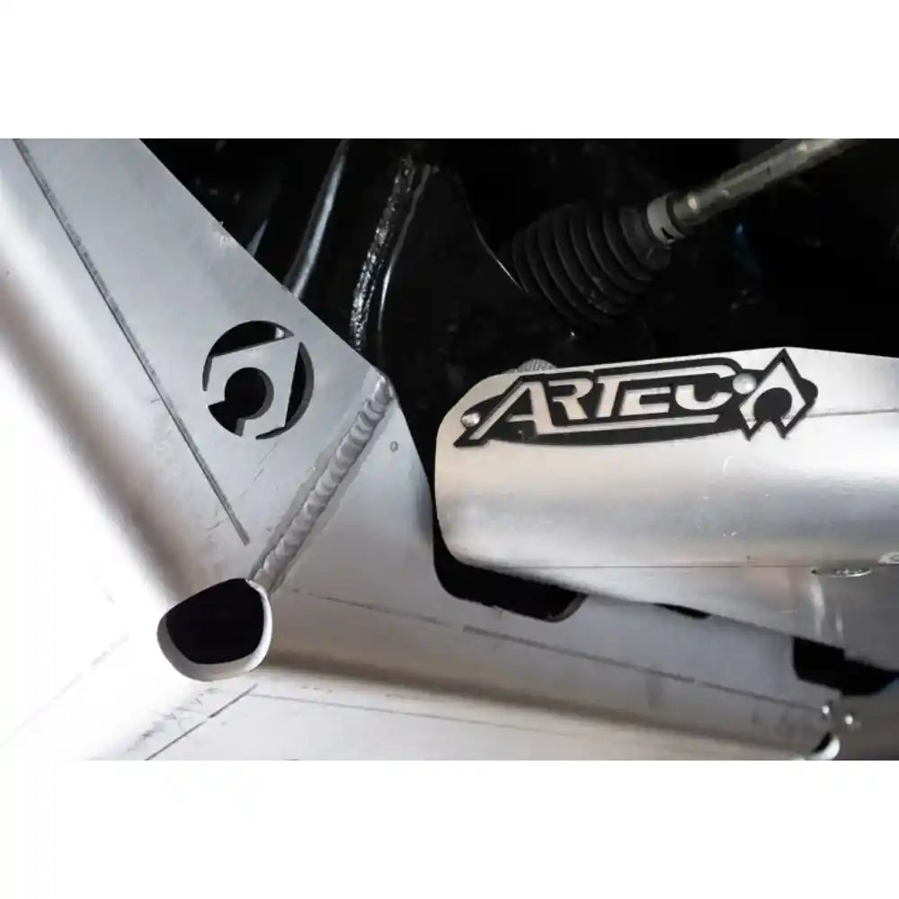 Close-up of a metal exhaust system with 'Artec' branding.