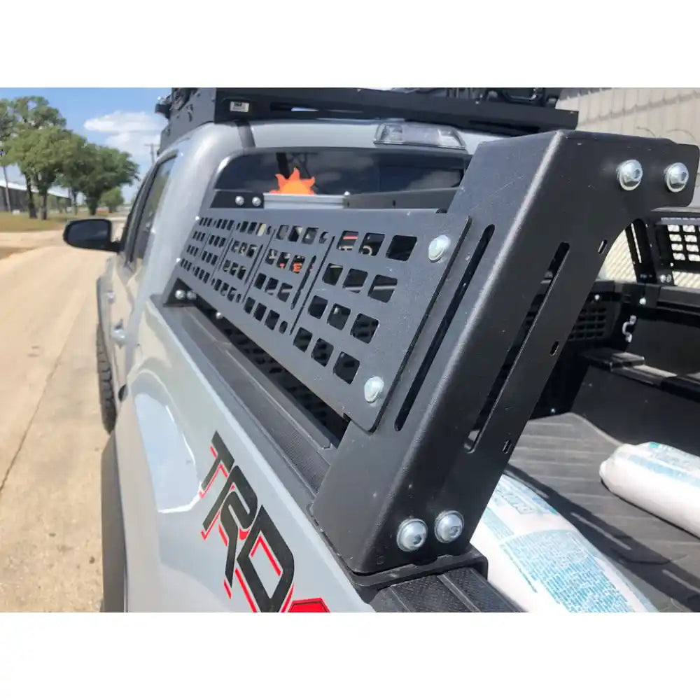 Close-up of a vehicle's bed rack with 'TRD' branding on a road.