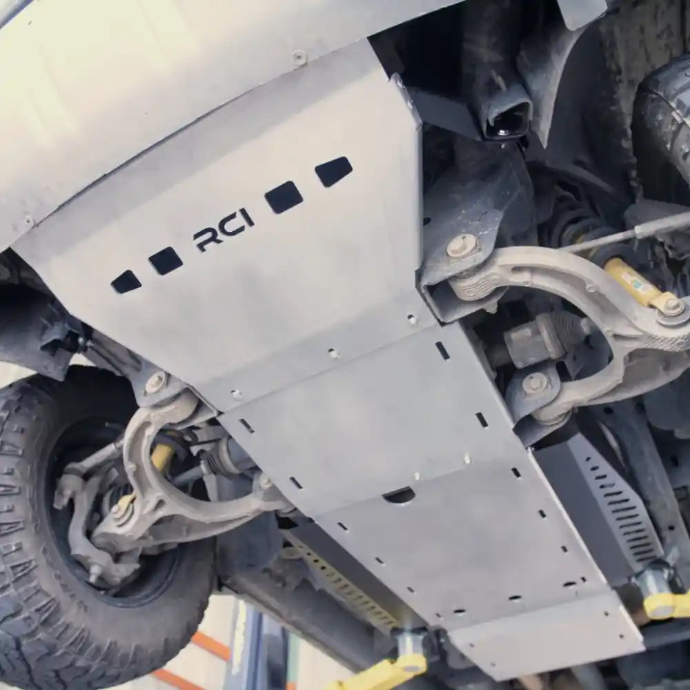 Close-up of black RCI logo branding on front skid plate section