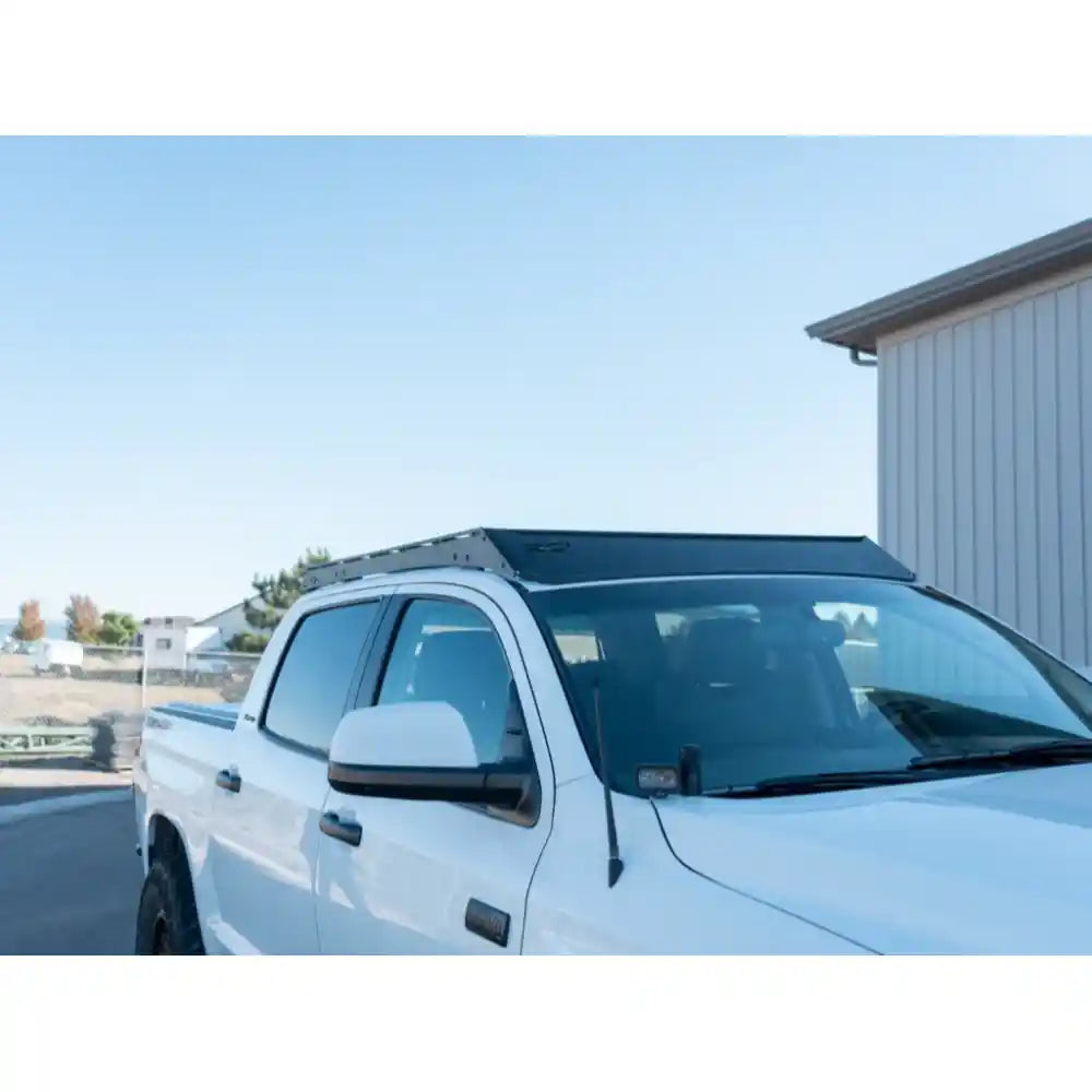 Close-up of black RCI roof rack showing T-slot channels and crossbar design