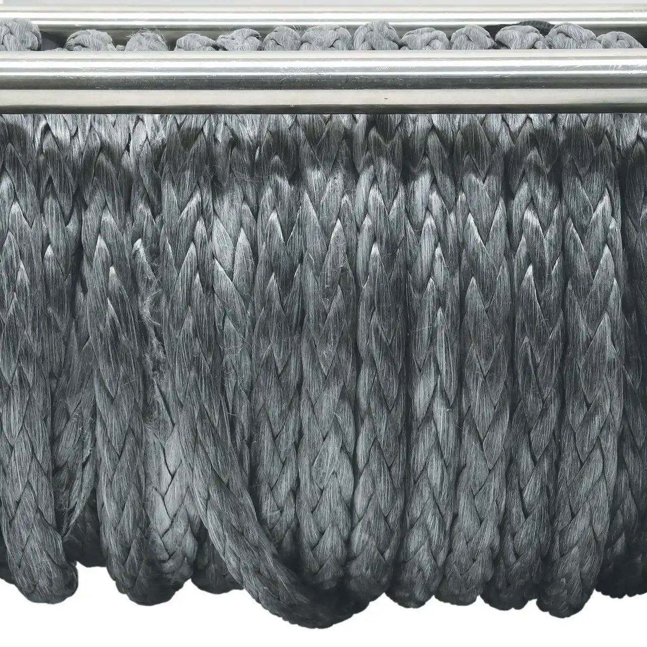 Close-up of braided synthetic rope on a reel with a metallic sheave.
