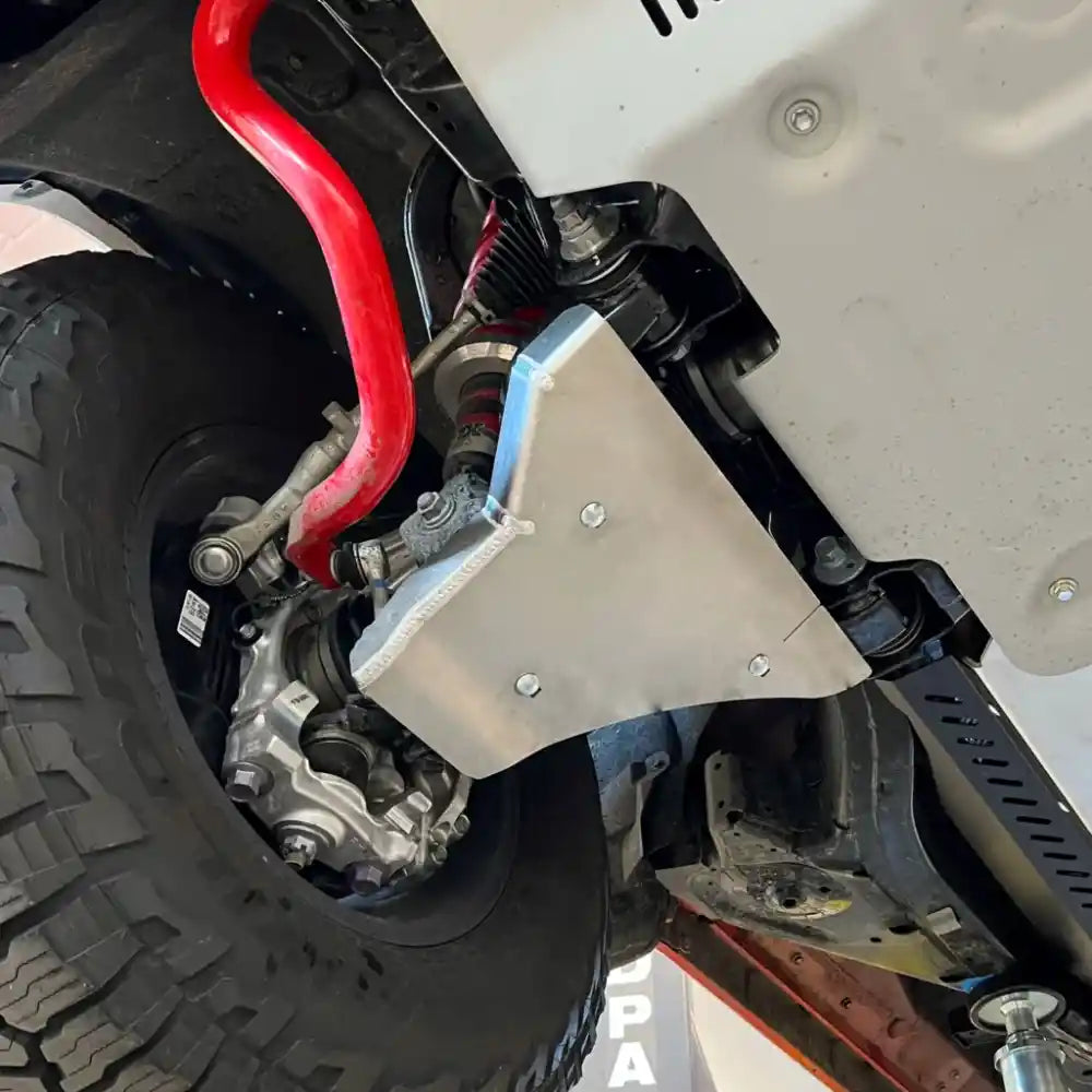 Close-up of installed front A-arm skid plate on Tundra