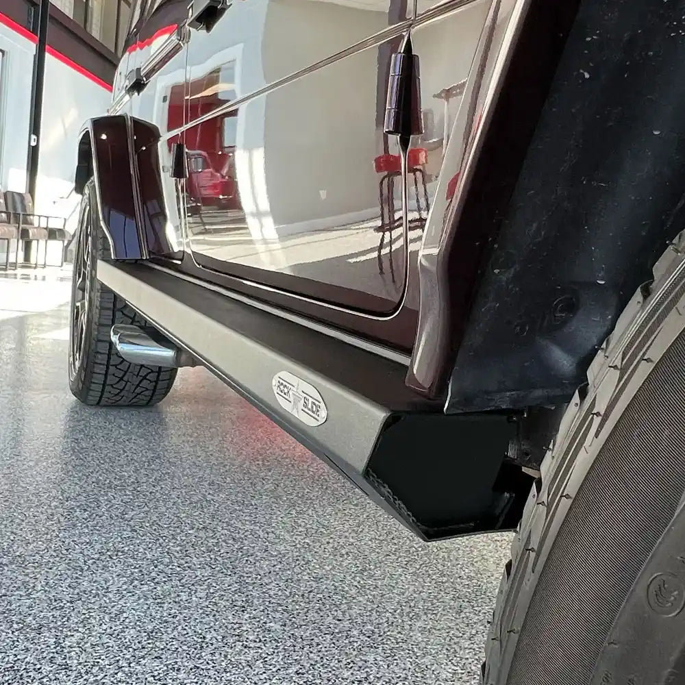 Close-up of maroon G-Class rock slider with deployed step