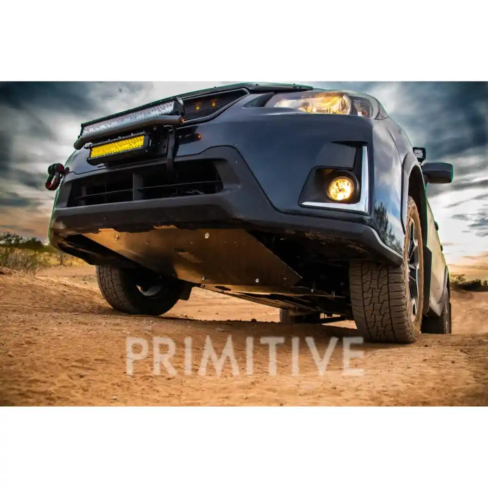 Crosstrek on a dirt road with 'Primitive' Skid plates