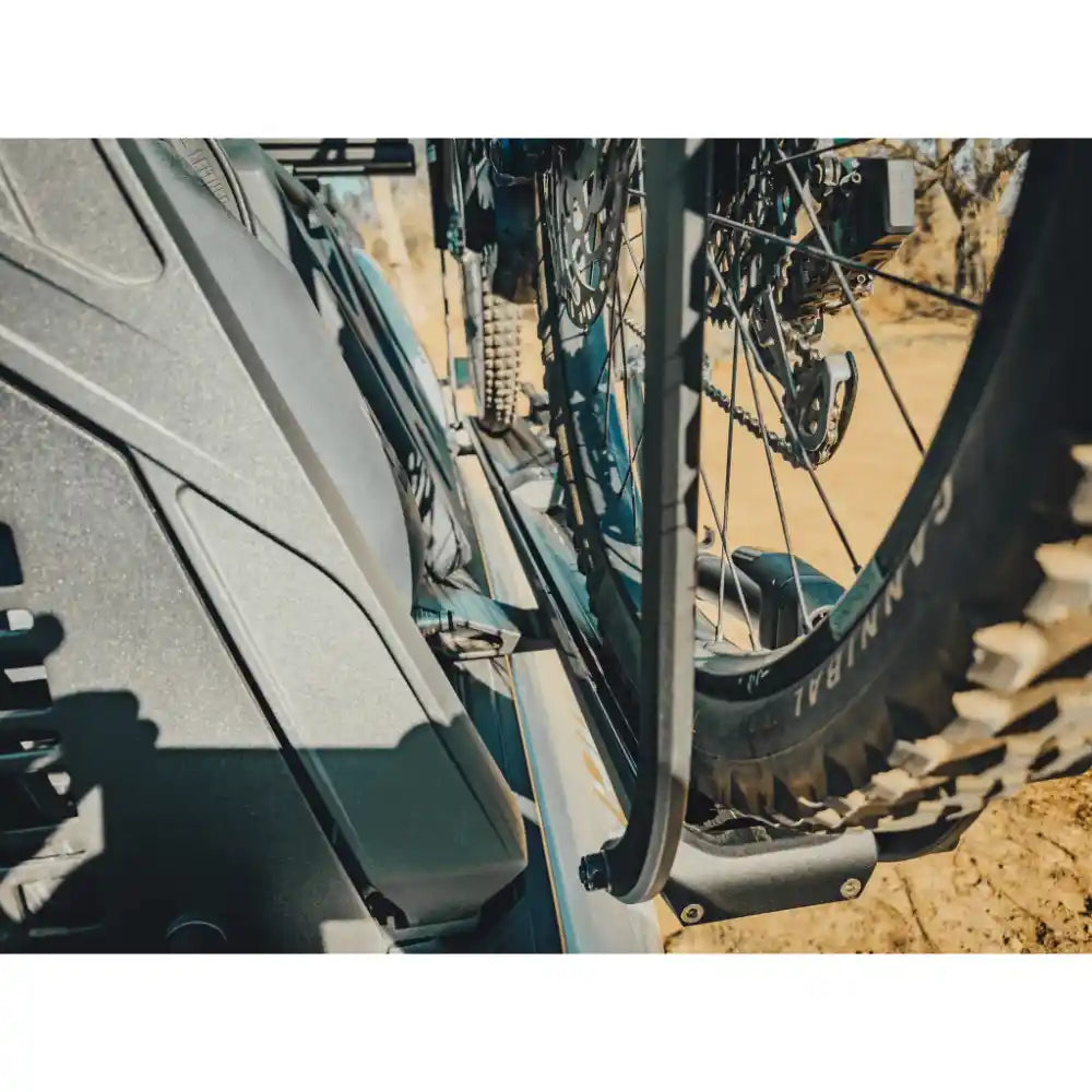 Detail view of wheel clamping arms holding tire firmly in place