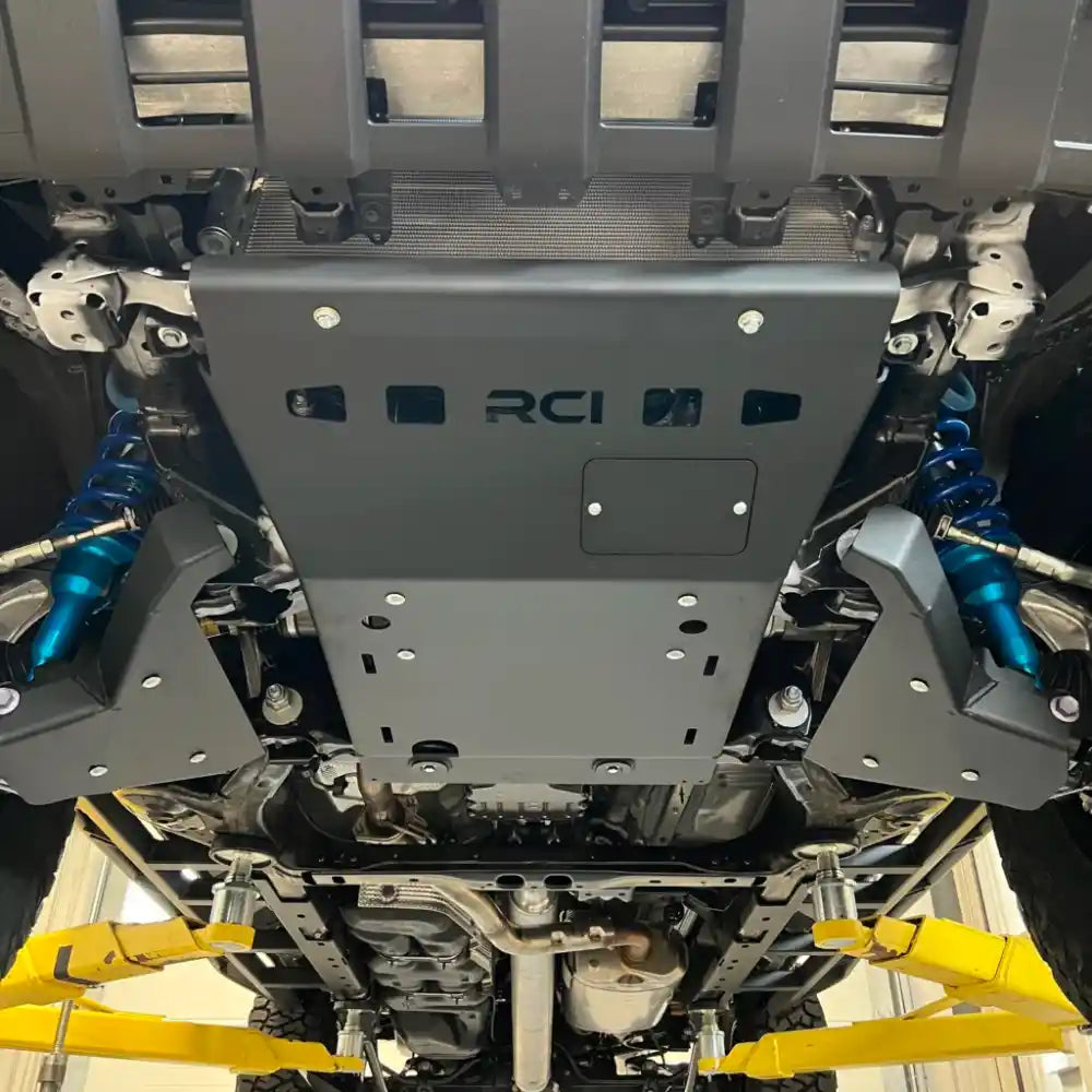 Detailed underside shot showing RCI A-arm protection around CV axles
