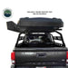 Black rooftop tent mounted on a Toyota Tacoma truck bed with Overland Vehicle Systems logo.