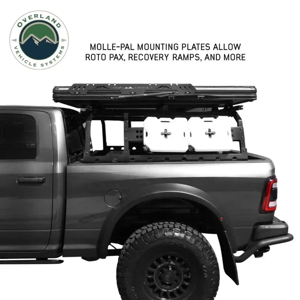 Grey truck with bed rack and Molle-Pal mounting plates on a white background, featuring Overland Vehicle Systems logo.