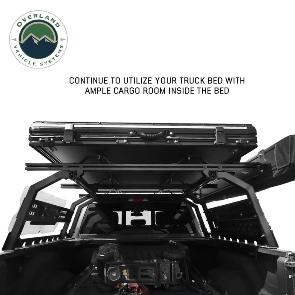 Truck bed with a storage system and Overland Vehicle Systems logo.