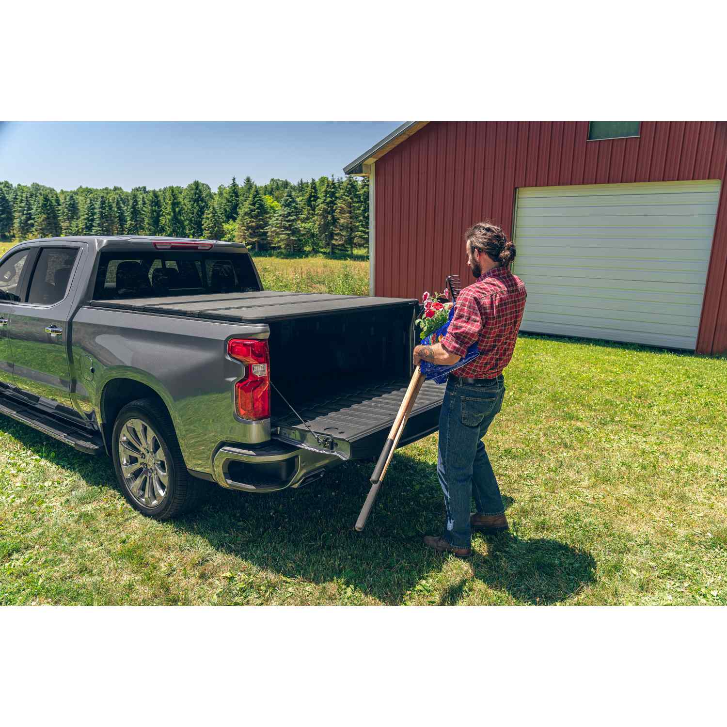 Extang Solid Fold ALX Tonneau Person Putting Stuff with Tailgate Open