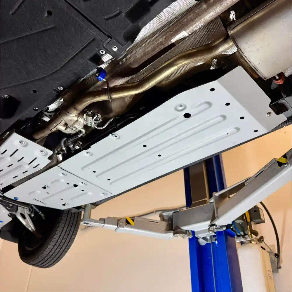 Exhaust and aluminum skid plates from angled view