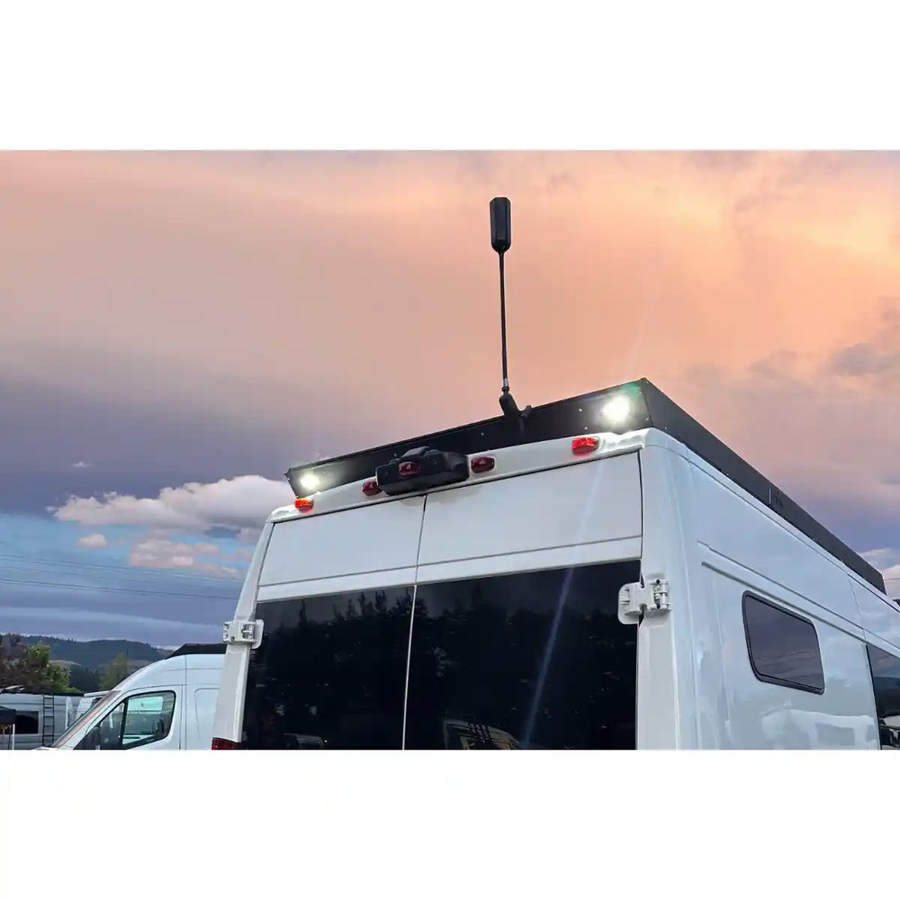 Back of a Promaster with scene lights with a sunset sky in the background