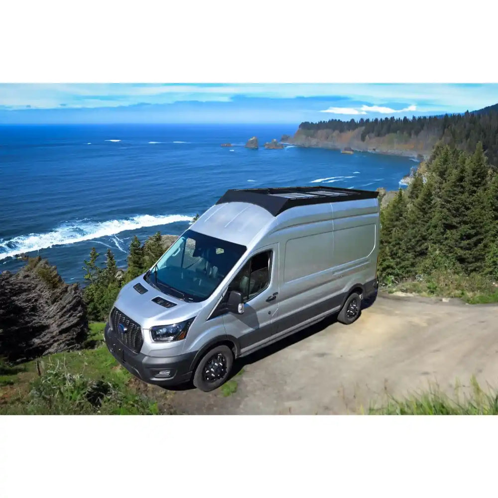 Transit with a Orion roof rack parked on a scenic coastal road.