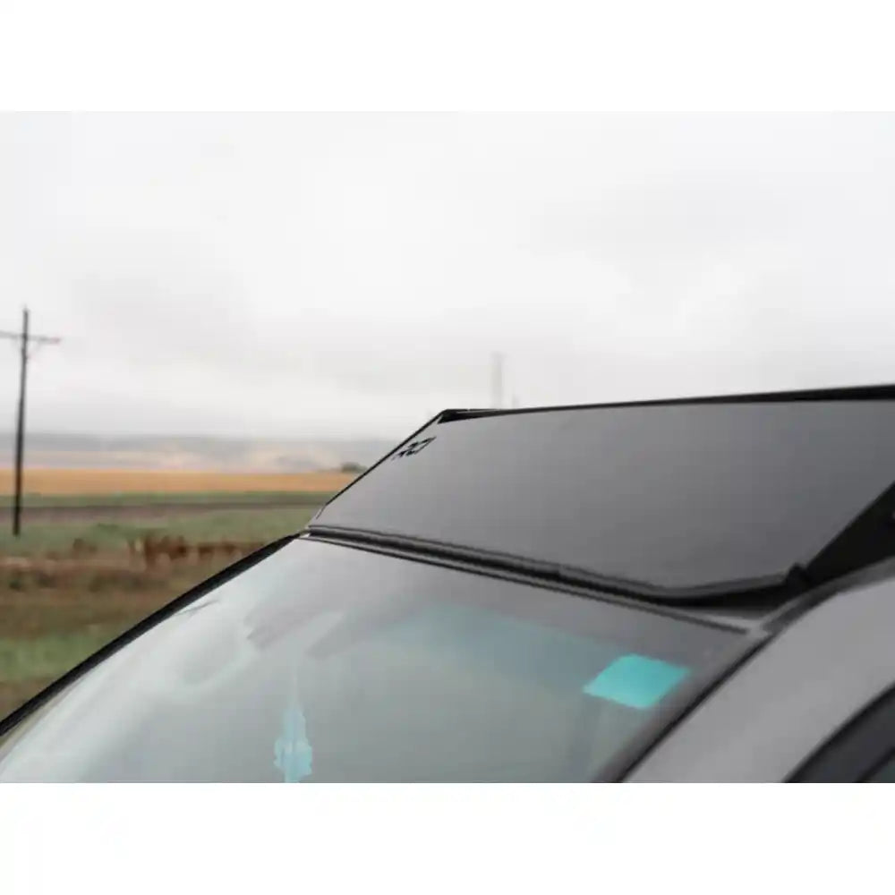 Front-roof perspective of black RCI rack installed on GX460 with subtle branding visible