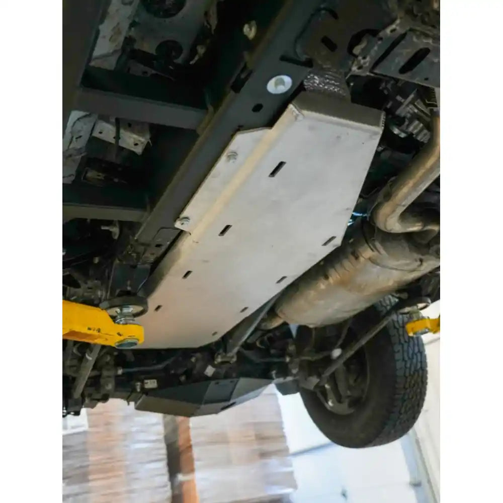 Fuel tank armor mounted near rear axle