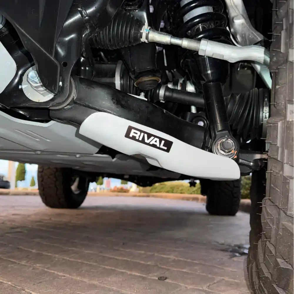 Full undercarriage view: RIVAL skids on both lower control arms