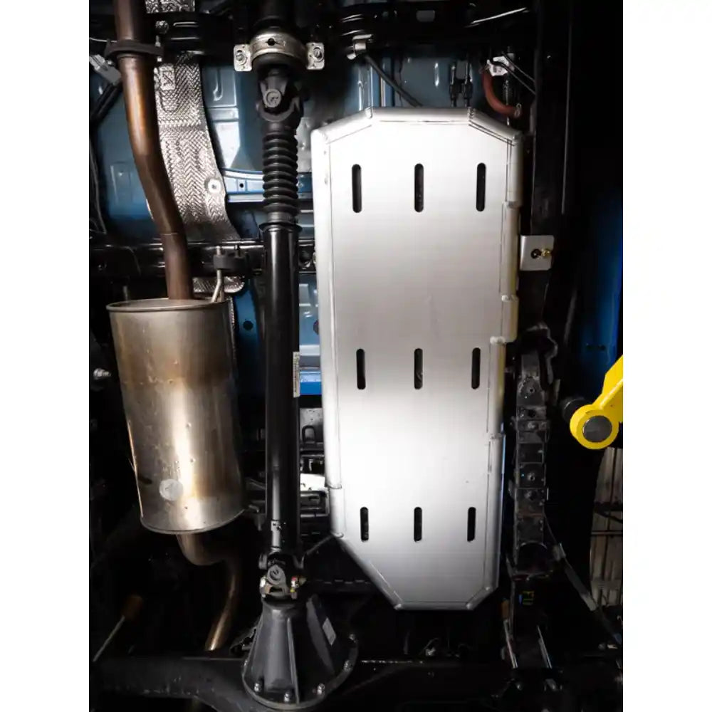 Gas Tank Artec skid plate on a 3rd Gen Tacoma's undercarriage with various mechanical components.