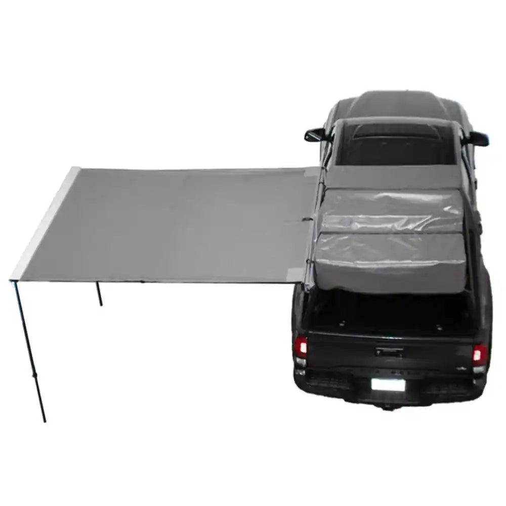 Car with a 90 degree gray awning extended over the back on a white background