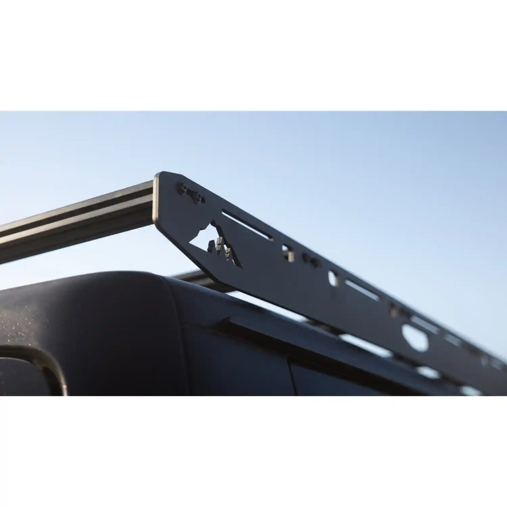 Black metal roof rack on a gladiator with a clear blue sky background