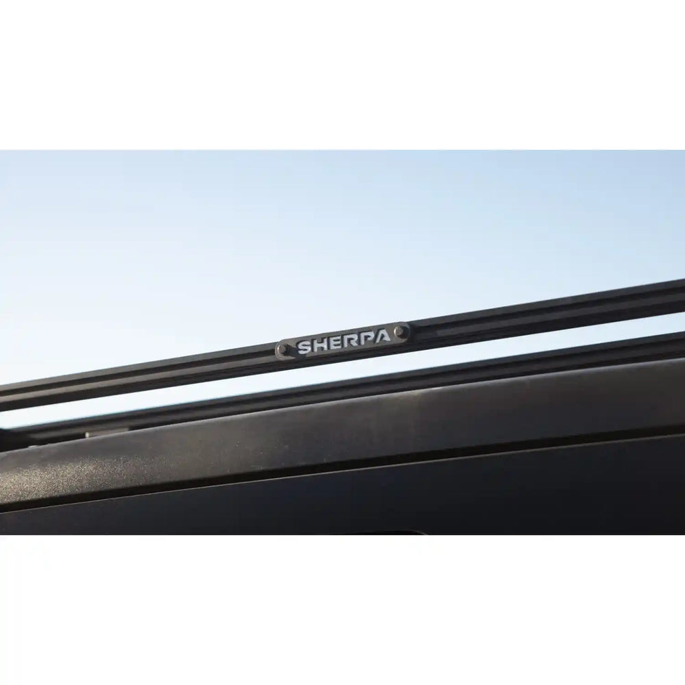Black Sherpa roof rack on a vehicle with a clear sky background