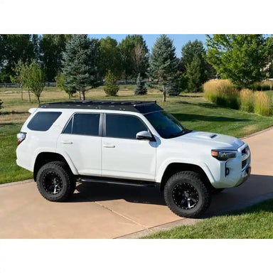 Hood-level view of white 4Runner featuring RCI rack in vibrant outdoor setting