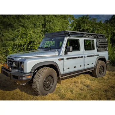 off-road Jeep with roof rack side view in outdoor setting
